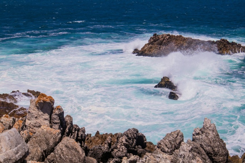 brown rocky shore with ocean waves during daytime