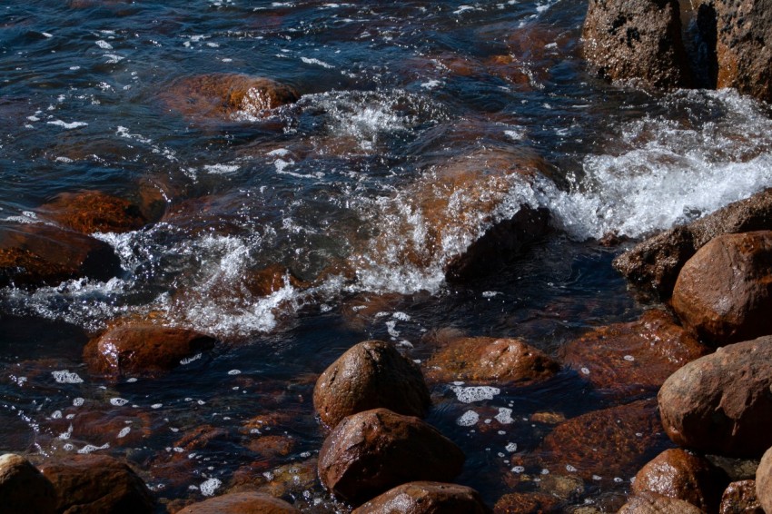 a rocky beach with a body of water