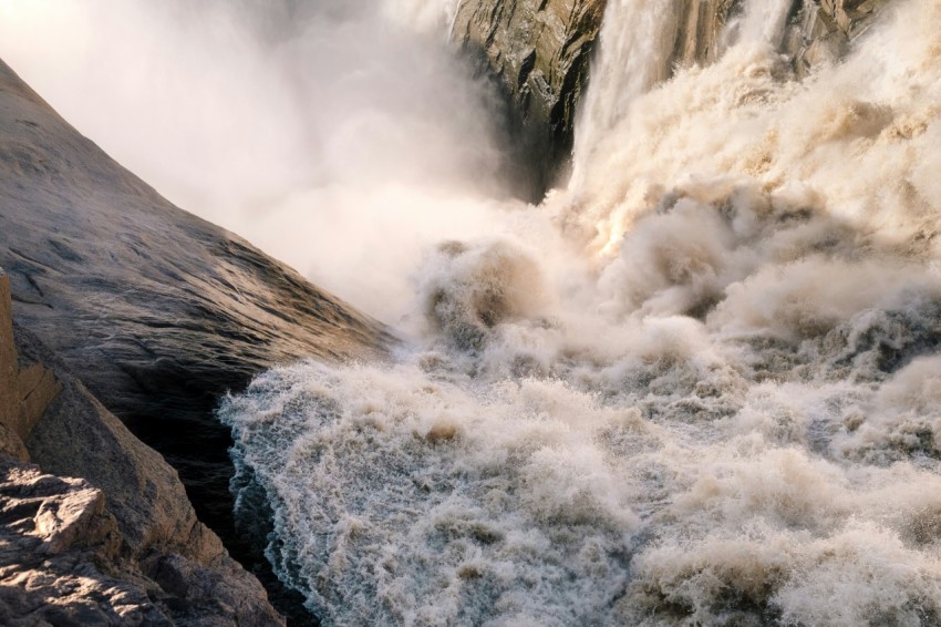 a large waterfall with lots of water coming out of it SaS