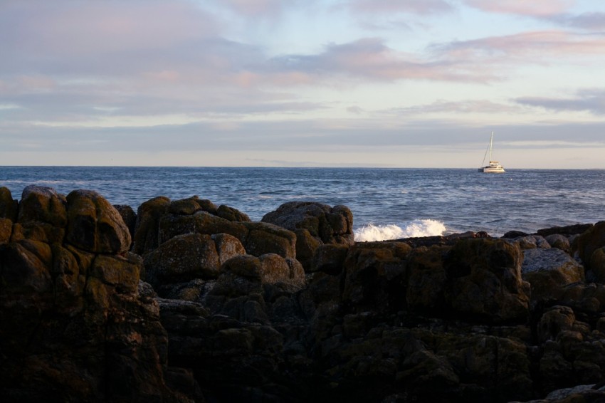 a boat is out in the ocean on a cloudy day