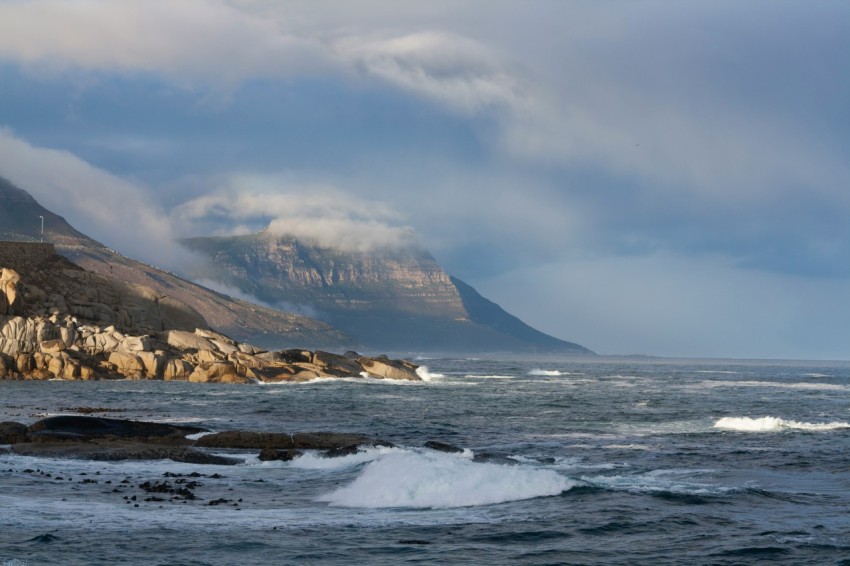 a large body of water with a mountain in the background