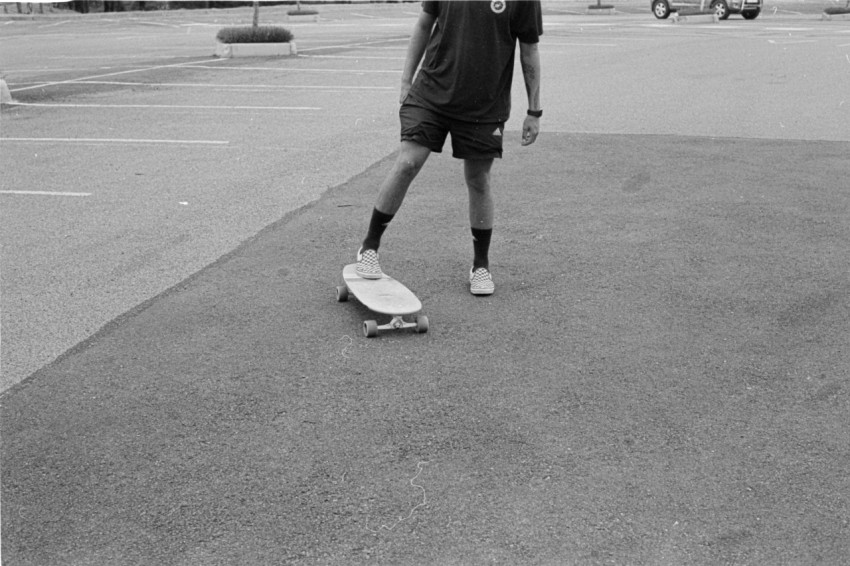 a man standing in a parking lot RIHQnLf5k