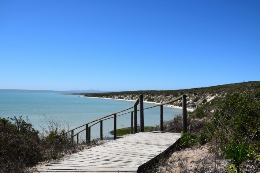 a wooden walkway leading to the beach