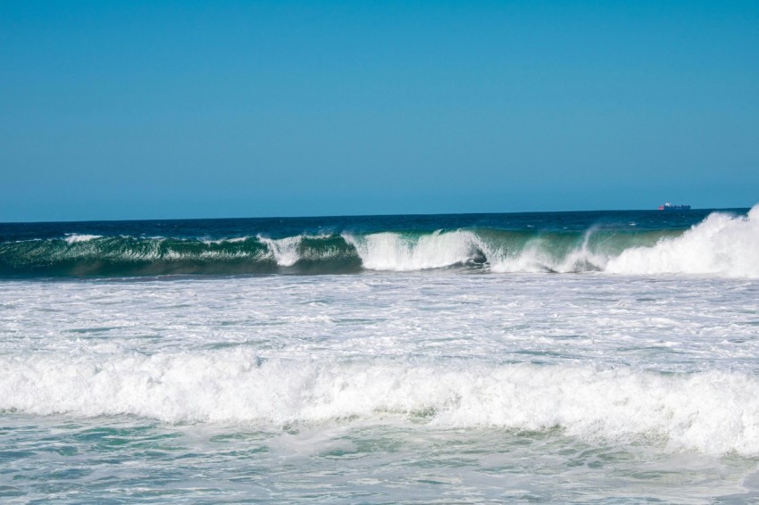 a man riding a wave on top of a surfboard