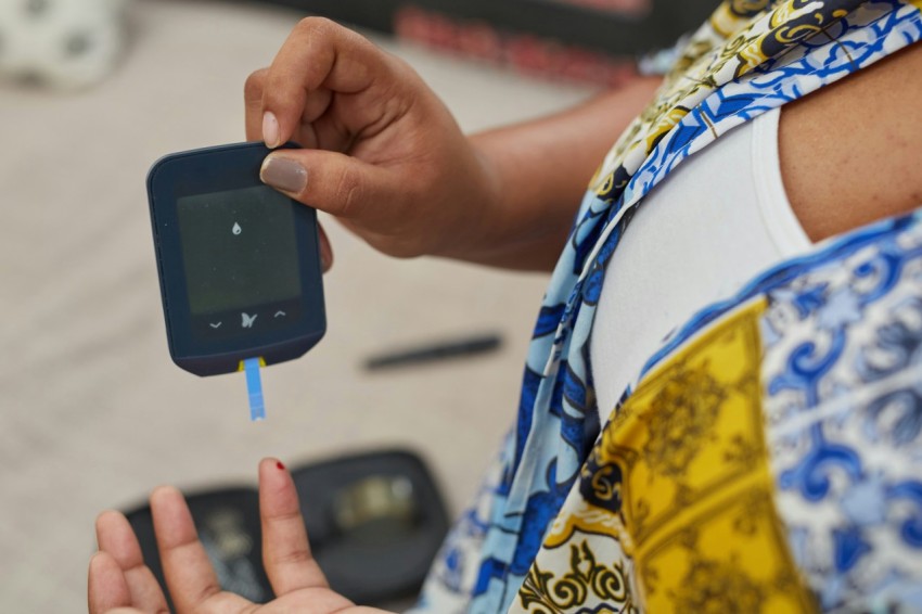 a person using a gluco meter