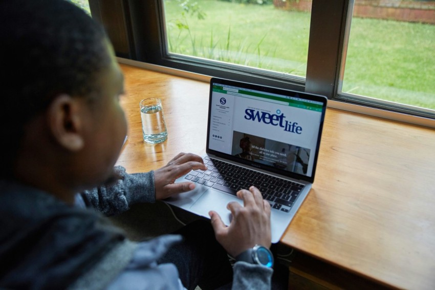 a man sitting in front of a laptop computer