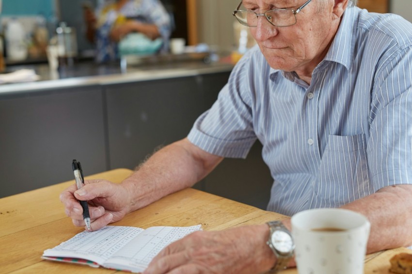 a person writing down blood glucose results