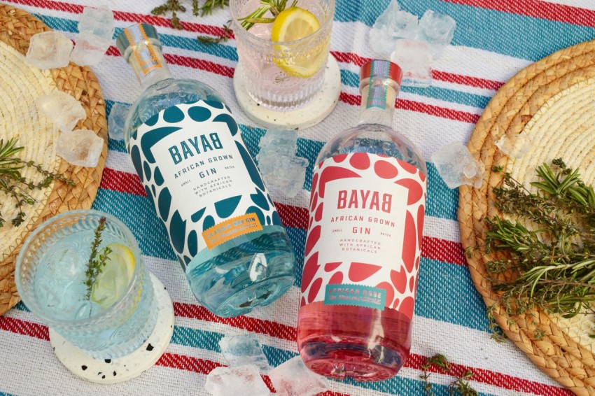 a table topped with bottles of alcohol and plates of food ut122