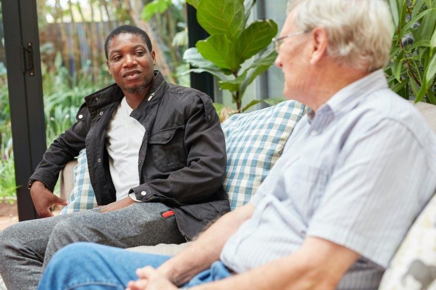 a couple of people sitting on top of a couch