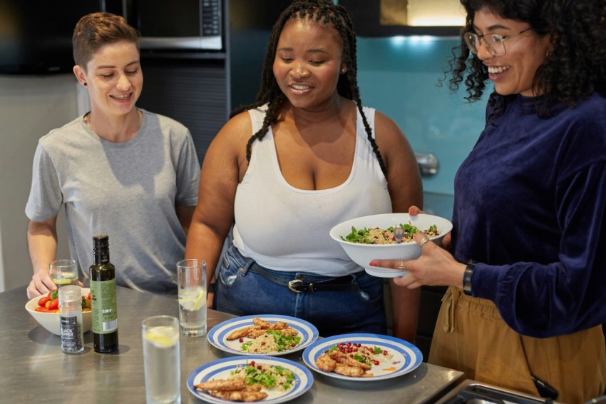 a group of people preparing food in a kitchen