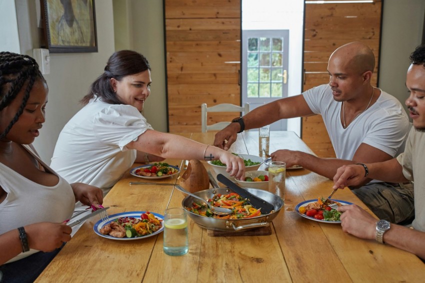 a group of people sitting around a table eating food