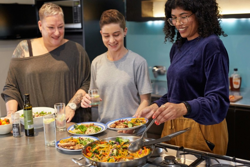 a group of people preparing food in a kitchen