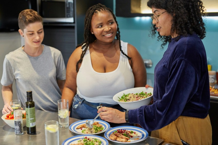 a group of people preparing food in a kitchen LUjEW