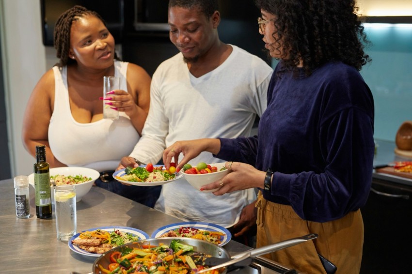 a group of people preparing food in a kitchen