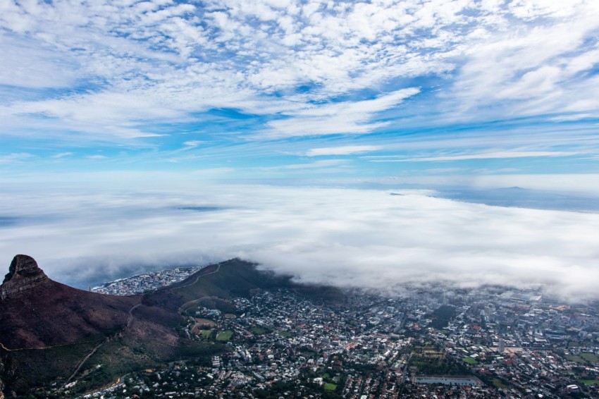 town and mountain under cloudy sky