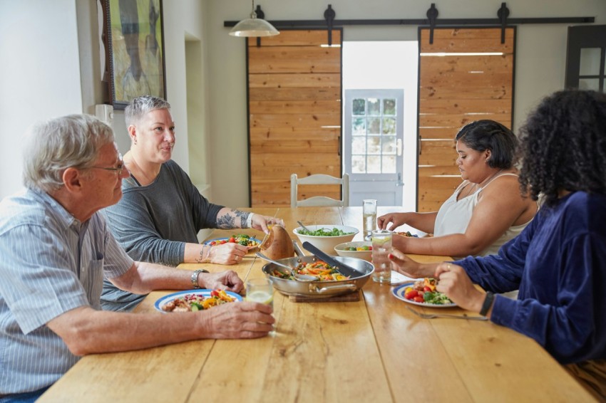 a group of people sitting around a table eating food