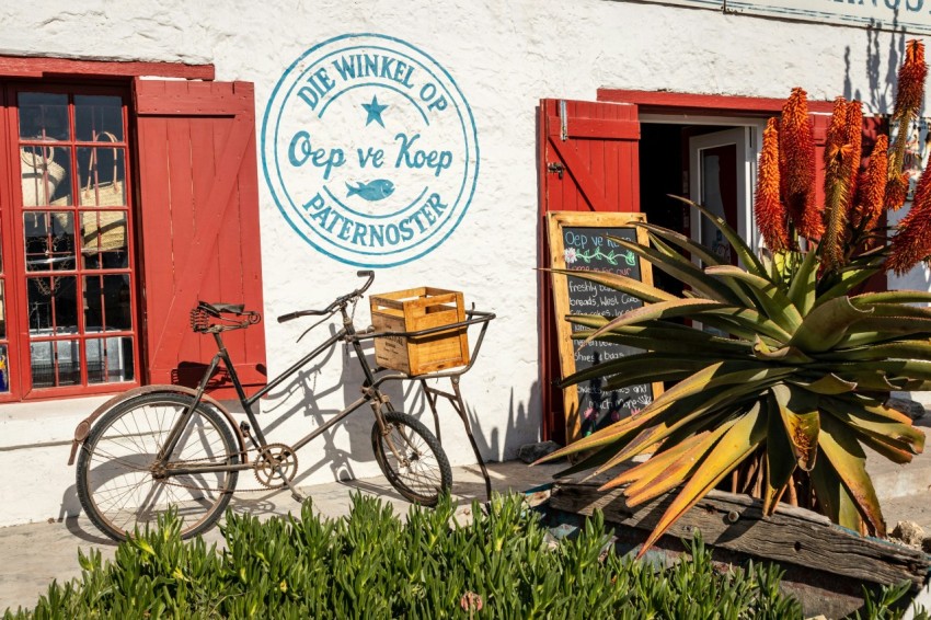 a bike parked outside of a building with red shutters