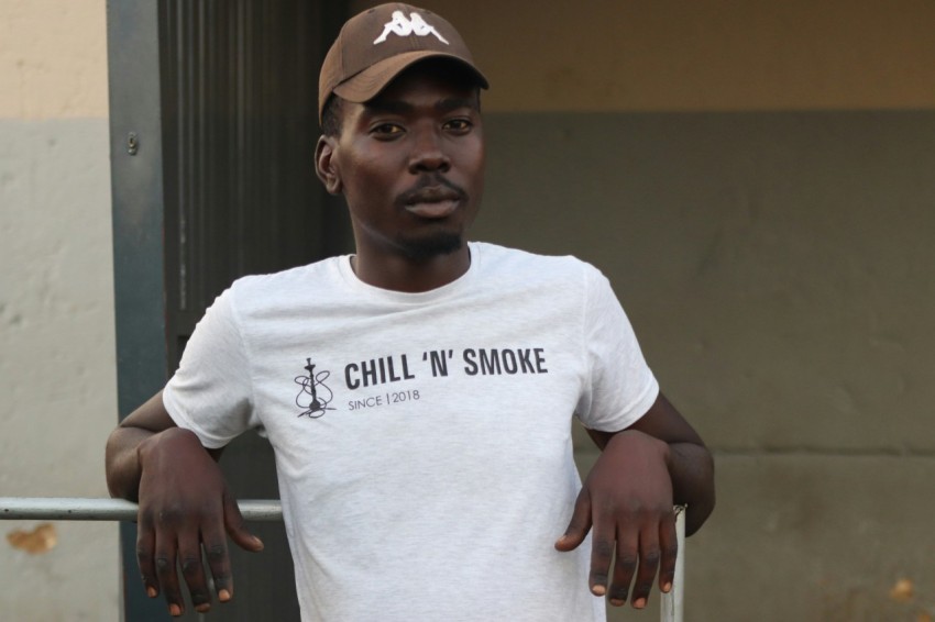 a man wearing a white shirt and a brown hat