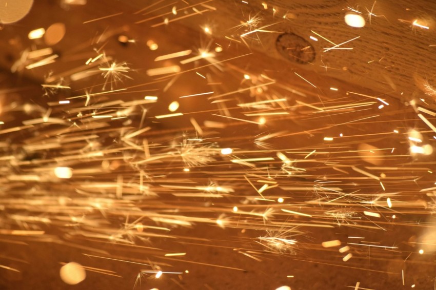 a close up of a clock on a wooden surface