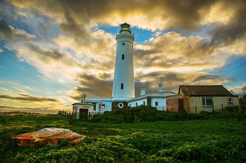 white lighthouse under cloudy sky during daytime