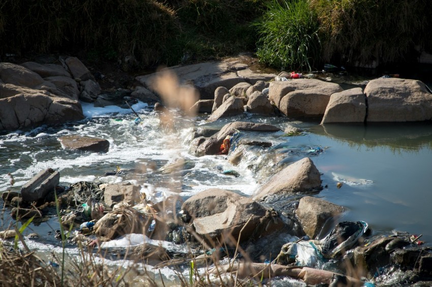 a river with rocks and a waterfall