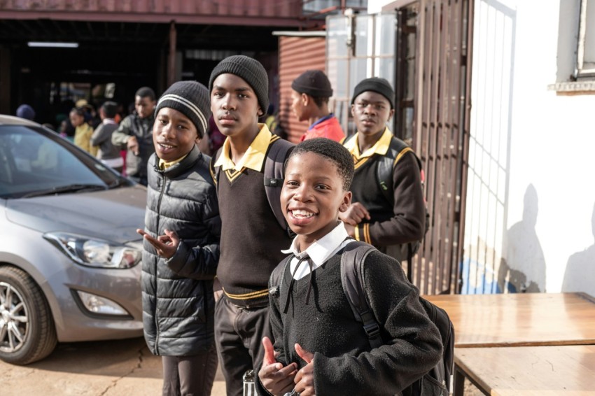 a group of young boys standing next to each other