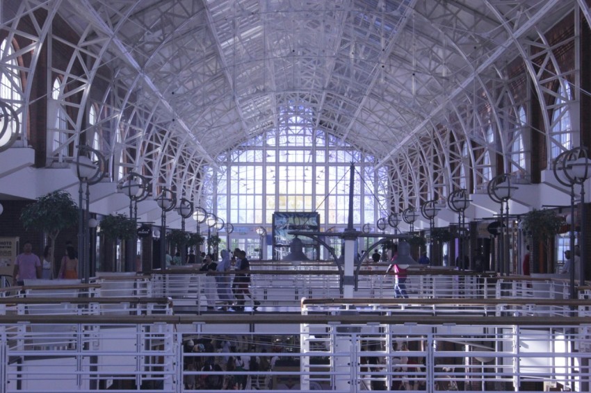 a train station with people walking inside of it