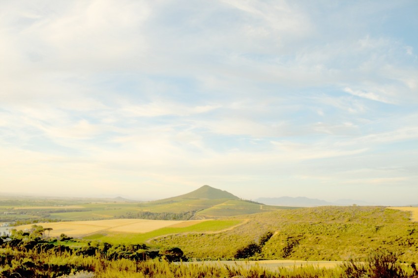 a view of a field with a mountain in the background