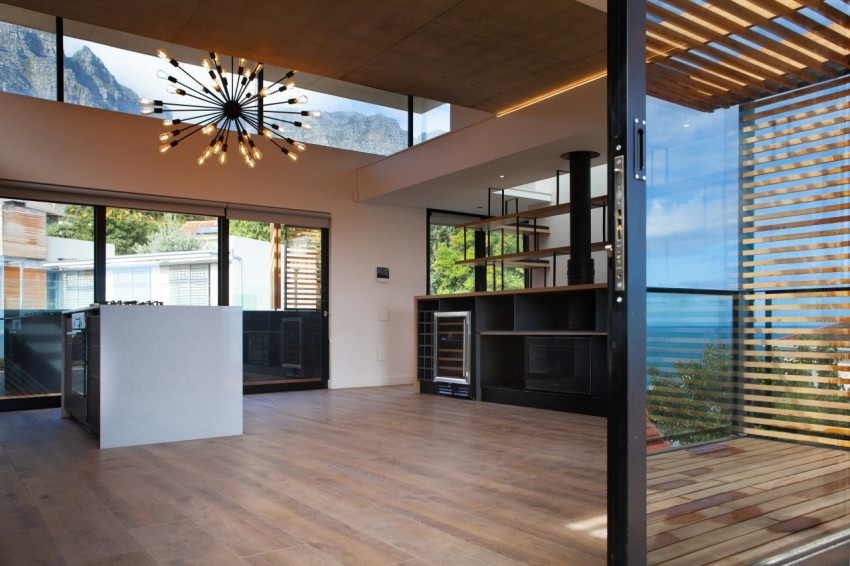 a room with a wood floor and large windows