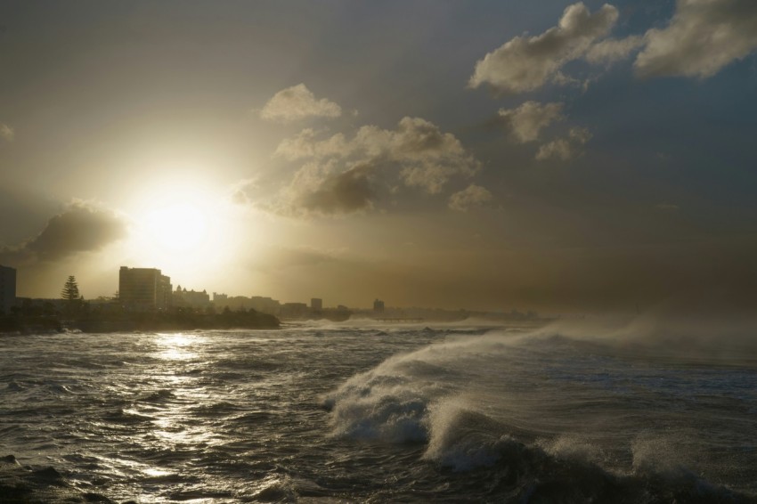 a large body of water with a city in the background