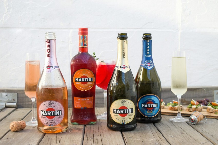 a group of bottles of wine sitting on top of a wooden table