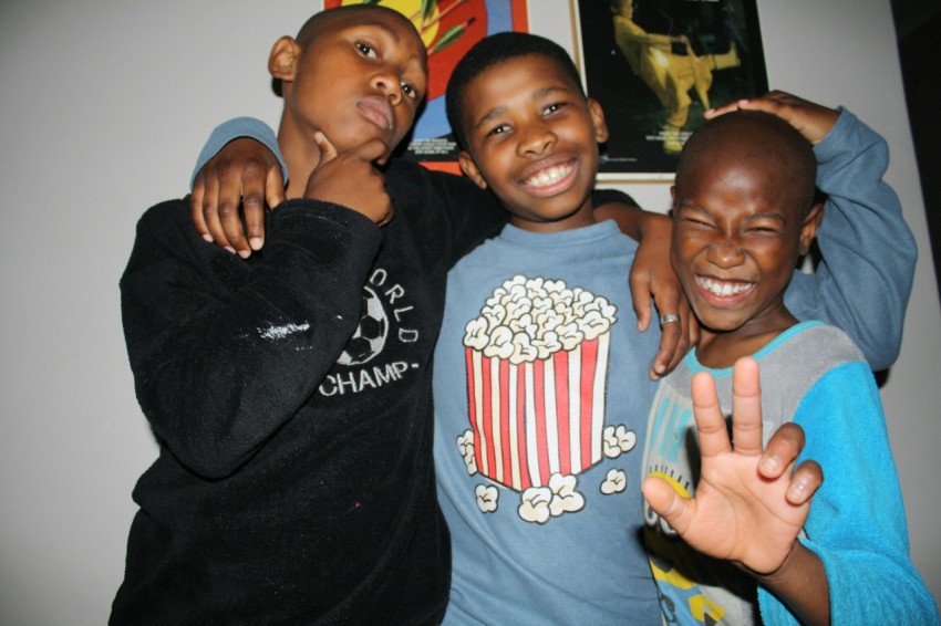 three young boys standing next to each other