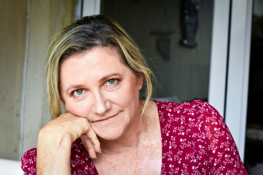 a woman in a red shirt is posing for a picture