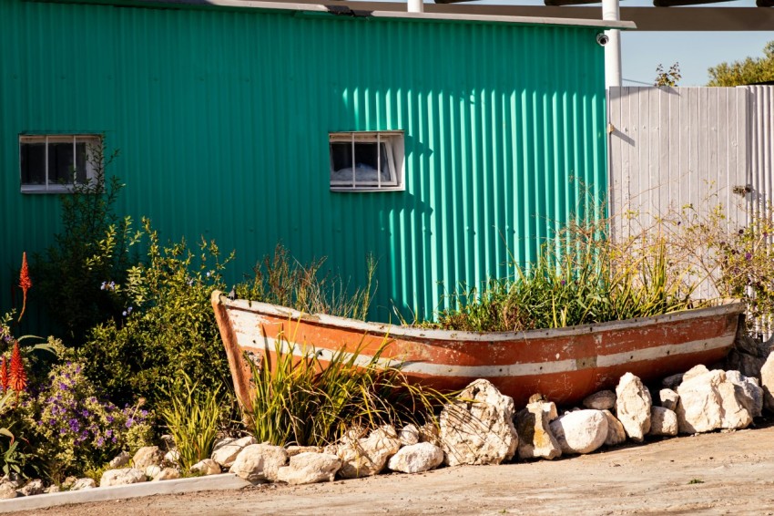 a boat sitting on top of a pile of rocks