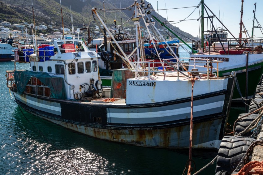 a boat docked in a harbor with other boats