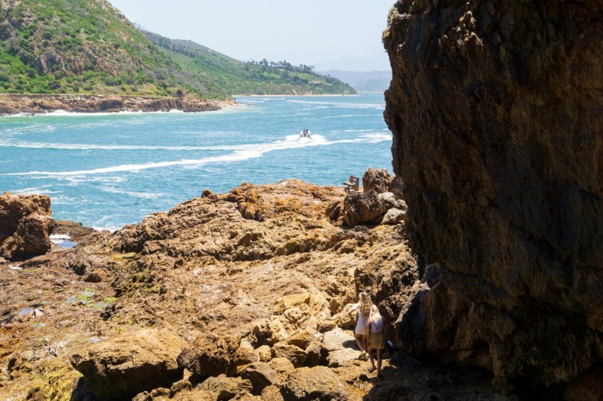 a rocky cliff overlooks a body of water