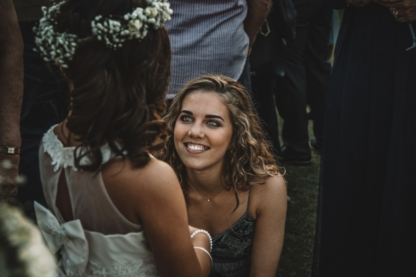 woman kneeling in front of a girl