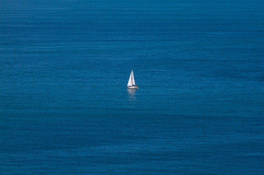 white sailboat on blue sea during daytime