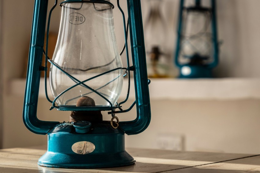 a blue lantern sitting on top of a table IcjG7V9