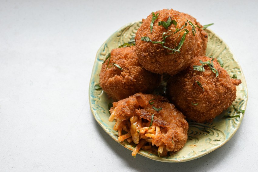 a green plate topped with fried food on top of a table