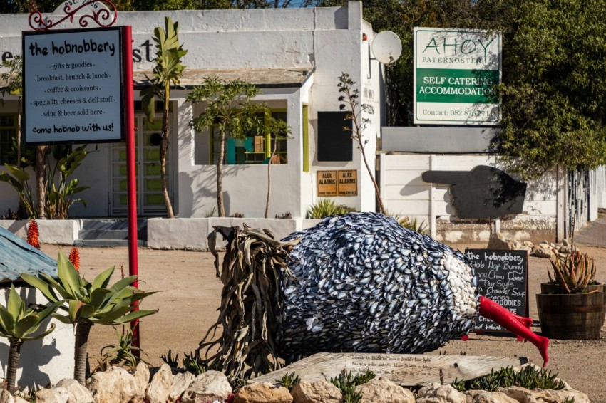 a sculpture of a bird on a rock in front of a building