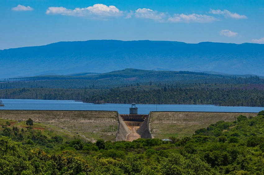 a view of a dam with a lake in the background