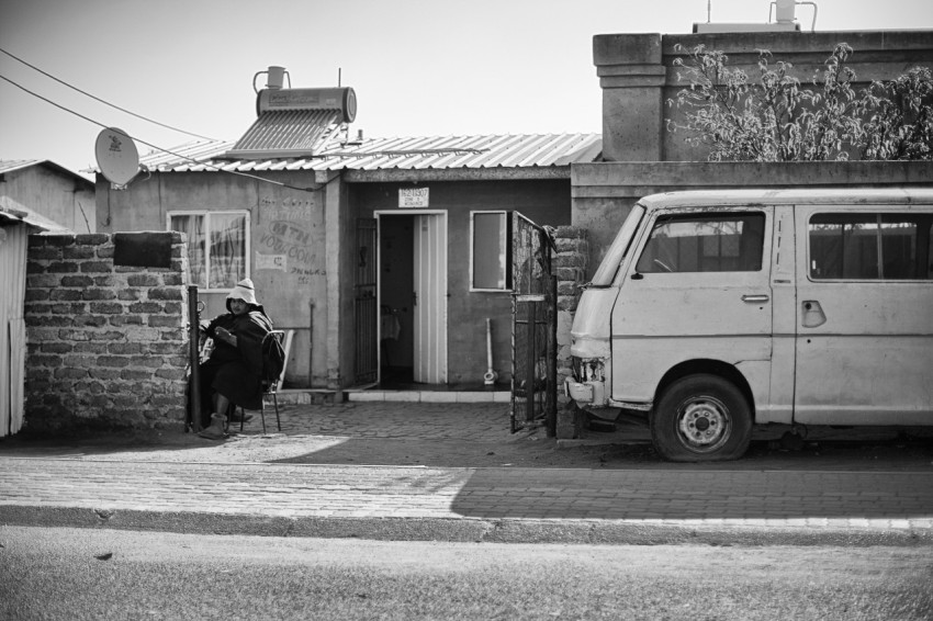 a person sitting in a chair in front of a van