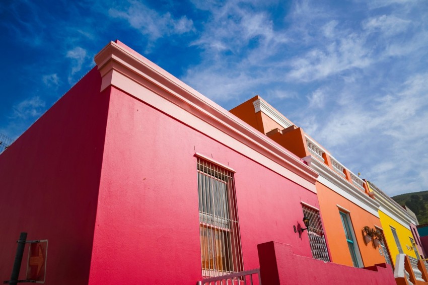 red and white concrete building under blue sky during daytime yG