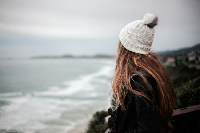 woman facing body of water