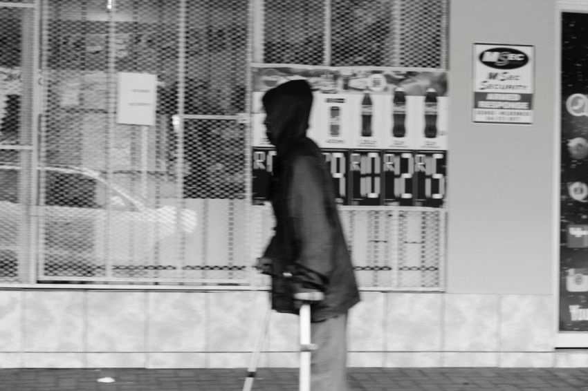 woman in black coat standing on gray concrete floor