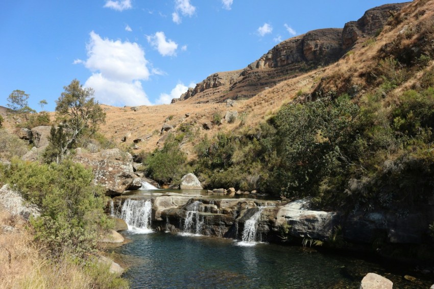 a small waterfall in the middle of a valley