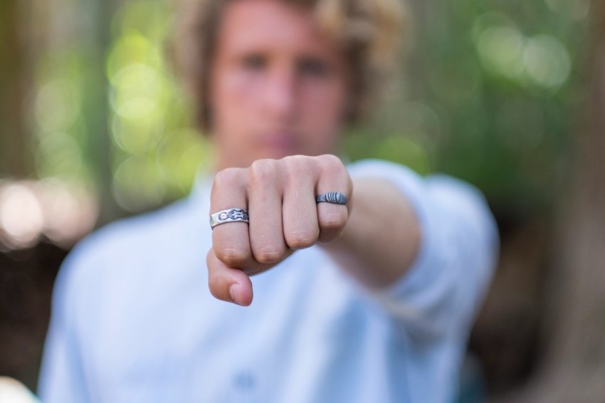 person wearing silver ring in white shirt