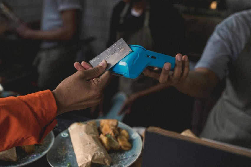 a person holding a blue object in their hand