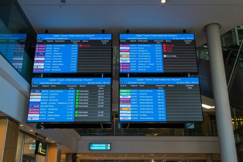 a couple of people walking through an airport